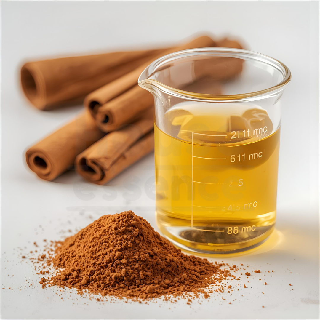 Beaker of liquid with cinnamon sticks and ground cinnamon on a white background
