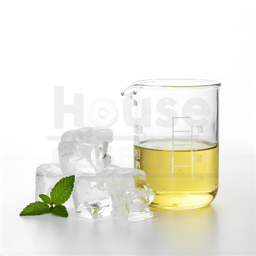 Clear glass beaker with yellow liquid, ice cubes, and a mint leaf on a white background