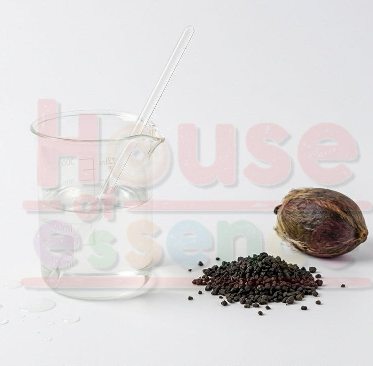 Glass with a straw, spices, and a nut on a white background